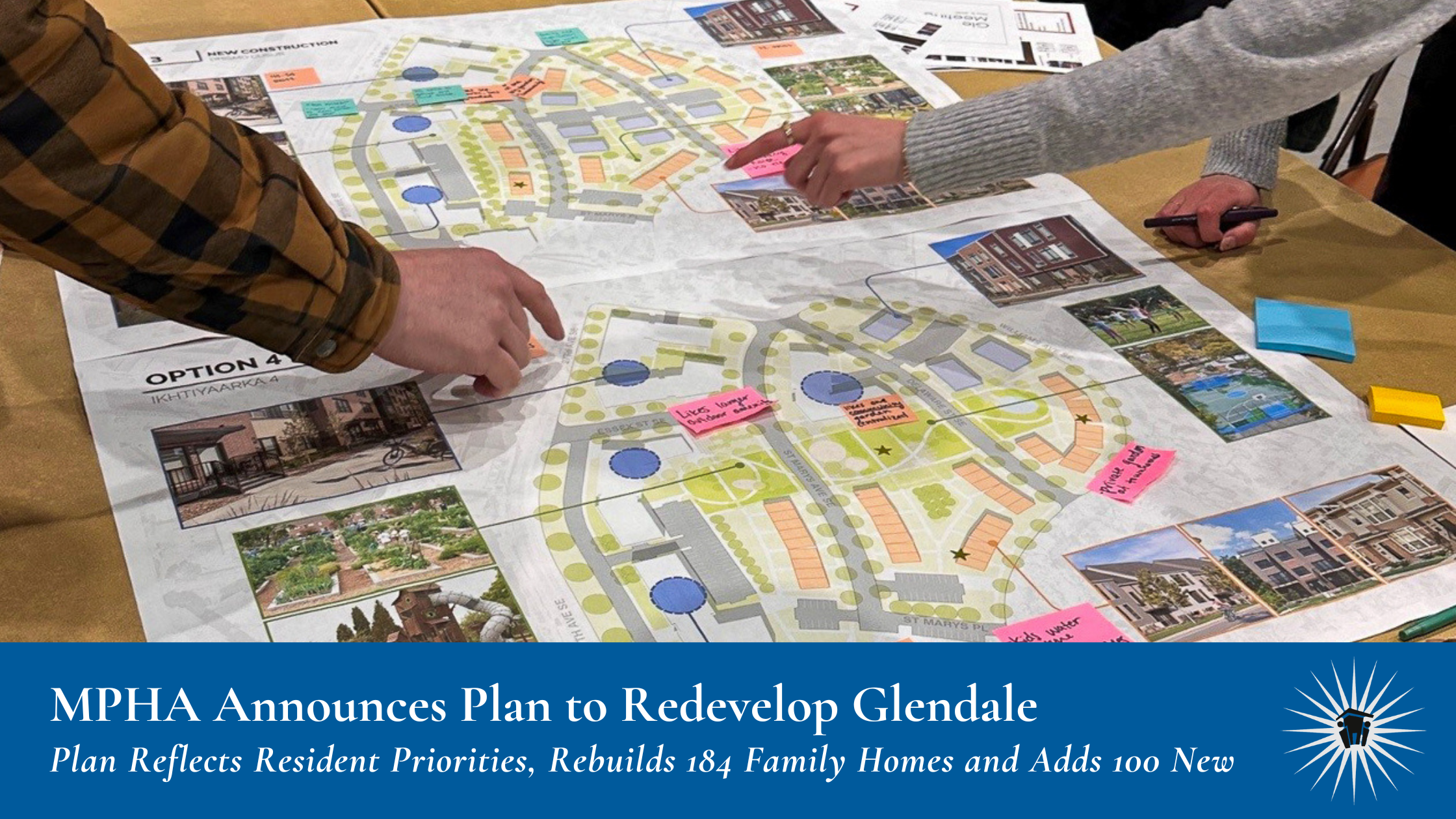 Two people point to a redevelopment plan map for Glendale, with photos and diagrams of housing options laid out on a table.