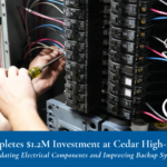 An electrician uses a screwdriver on a circuit breaker panel. Text below reads: “MPHA Completes $1.2M Investment at Cedar High-Rise. Work Included Updating Electrical Components and Improving Backup Systems.”